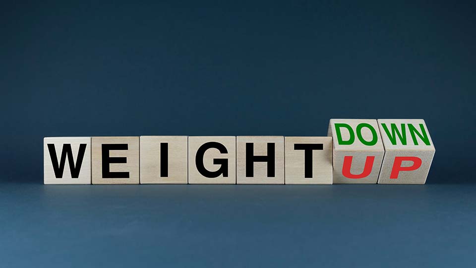 Letter cubes spelling out weight up weight down